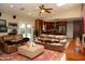 Bright living room featuring vaulted ceilings, sliding glass doors, and comfortable leather couches at 6529 E Voltaire Ave, Scottsdale, AZ 85254