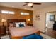 Bedroom with wood floors, a ceiling fan, and access to other rooms at 6529 E Voltaire Ave, Scottsdale, AZ 85254
