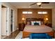 Bedroom with wood floors, ceiling fan and access to closet at 6529 E Voltaire Ave, Scottsdale, AZ 85254