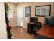 An office space with a desk, a world map and a printer near a door leading to the outside at 6529 E Voltaire Ave, Scottsdale, AZ 85254