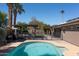 Backyard pool and pergola, surrounded by lush landscaping and privacy fencing at 6529 E Voltaire Ave, Scottsdale, AZ 85254