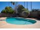 Sparkling pool with a diving board surrounded by desert landscaping and a privacy fence at 6529 E Voltaire Ave, Scottsdale, AZ 85254