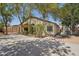 Exterior showcasing the property's backyard with mature trees and a covered patio at 6659 W Oraibi Dr, Glendale, AZ 85308
