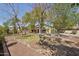 Large backyard with mature trees offering shade and privacy, plus a covered patio at 6659 W Oraibi Dr, Glendale, AZ 85308