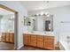 Bathroom featuring double sink vanity, tile floors, and large mirror at 6659 W Oraibi Dr, Glendale, AZ 85308