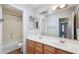 Bright bathroom with a double sink vanity and a shower/tub combo at 6659 W Oraibi Dr, Glendale, AZ 85308