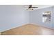 This light-filled bedroom has tile floors and a ceiling fan for comfortable living at 6659 W Oraibi Dr, Glendale, AZ 85308