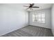 Cozy bedroom features neutral carpet and paint, ceiling fan, and a window at 6659 W Oraibi Dr, Glendale, AZ 85308