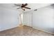 This bedroom features tile floors, ceiling fan, and access to other rooms at 6659 W Oraibi Dr, Glendale, AZ 85308