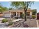 Single-story house shows tile roof, desert landscaping, and covered front porch and two-car garage at 6659 W Oraibi Dr, Glendale, AZ 85308