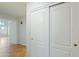 Hallway leading to bright living space, with a sliding door closet for storage at 6659 W Oraibi Dr, Glendale, AZ 85308
