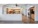 Spacious kitchen with granite countertops and stainless steel appliances open to the living area at 6659 W Oraibi Dr, Glendale, AZ 85308