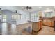 Open kitchen with a central island, stainless appliances, and adjacent living area at 6659 W Oraibi Dr, Glendale, AZ 85308