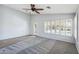 Bright room with neutral paint and carpet, with plantation shutters and a glass door at 6659 W Oraibi Dr, Glendale, AZ 85308