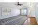 Spacious living room features plush carpet, stylish ceiling fan, plantation shutters, and an open layout at 6659 W Oraibi Dr, Glendale, AZ 85308