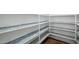 Walk-in pantry with custom shelving for ample storage at 6659 W Oraibi Dr, Glendale, AZ 85308