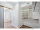 A walk-in closet offers built-in shelving and hanging rods, providing organized storage solutions at 6659 W Oraibi Dr, Glendale, AZ 85308