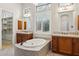 A luxurious bathroom with dual vanities, a garden tub and a stylish chandelier at 7201 E Sandia Cir, Mesa, AZ 85207