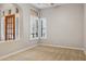 Neutral bedroom features a wood door and shuttered windows for great light control at 7201 E Sandia Cir, Mesa, AZ 85207