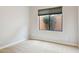 This bedroom has neutral carpet, paint and a window with a view of exterior foliage at 7201 E Sandia Cir, Mesa, AZ 85207