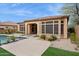 Rear of the home, showing the backyard with landscaping and hardscaping, plus plenty of windows at 7201 E Sandia Cir, Mesa, AZ 85207