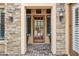 Inviting front entryway with stone accents and decorative sconces, offering curb appeal at 7201 E Sandia Cir, Mesa, AZ 85207