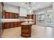 Open kitchen featuring granite countertops, custom cabinets, and a large center island at 7201 E Sandia Cir, Mesa, AZ 85207