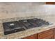 Modern stainless steel gas range with granite countertops and tile backsplash at 7201 E Sandia Cir, Mesa, AZ 85207