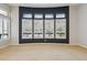 Bright living room with dark accent wall and large shuttered windows at 7201 E Sandia Cir, Mesa, AZ 85207