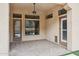 Covered outdoor patio with brick flooring, a ceiling fan, and multiple doorways providing great views at 7201 E Sandia Cir, Mesa, AZ 85207