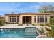 Backyard pool with the home in the background and desert landscaping at 7201 E Sandia Cir, Mesa, AZ 85207