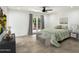 Light bedroom featuring neutral decor, tiled floors, and access to the outdoors through French doors at 7245 E Buena Terra Way, Scottsdale, AZ 85250