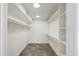 Walk-in closet features laminate floors, overhead lighting, and shelving at 7245 E Buena Terra Way, Scottsdale, AZ 85250