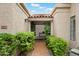 Charming front entrance with a tiled walkway, lush landscaping, and covered porch at 7245 E Buena Terra Way, Scottsdale, AZ 85250