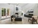 Bright, modern living room featuring a fireplace, tiled floor, and contemporary furnishings at 7245 E Buena Terra Way, Scottsdale, AZ 85250