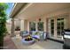 Inviting outdoor patio with a fire pit, comfortable seating, grill and a well-maintained surface at 7245 E Buena Terra Way, Scottsdale, AZ 85250