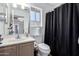Bathroom featuring a vanity with sink, toilet, and shower with dark shower curtain at 7650 E Williams Dr # 1011, Scottsdale, AZ 85255
