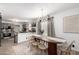 Elegant dining room with a modern chandelier, stylish table, and open access to the kitchen at 7650 E Williams Dr # 1011, Scottsdale, AZ 85255