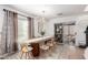Bright dining area featuring a modern light fixture, large table, and sliding glass doors to the backyard at 7650 E Williams Dr # 1011, Scottsdale, AZ 85255