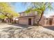 View of a two-story home with a neutral color scheme, large windows, and a two-car garage at 7650 E Williams Dr # 1011, Scottsdale, AZ 85255