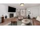 Modern living room with a fireplace, comfortable seating, and a neutral color palette at 7650 E Williams Dr # 1011, Scottsdale, AZ 85255