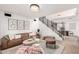 Spacious living room with modern decor, comfortable seating, and a staircase leading upstairs at 7650 E Williams Dr # 1011, Scottsdale, AZ 85255