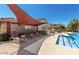 Community pool area with lounge chairs and sunshades at 7650 E Williams Dr # 1011, Scottsdale, AZ 85255