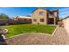 Expansive backyard features a green lawn and a two-story home at 811 E Gold Dust Way, San Tan Valley, AZ 85143