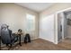 Bedroom features a window with blinds, an office chair, a desk, a weight rack, and a closet at 811 E Gold Dust Way, San Tan Valley, AZ 85143