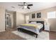 This modern bedroom is well lit by a ceiling fan with neutral colors and simple artwork at 811 E Gold Dust Way, San Tan Valley, AZ 85143