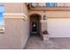 Welcoming entrance with a decorative front door, a tiled walkway, and a charming planter with vibrant flowers at 811 E Gold Dust Way, San Tan Valley, AZ 85143