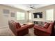 Inviting living room with plush leather seating and a mounted television at 811 E Gold Dust Way, San Tan Valley, AZ 85143