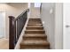 Carpeted stairs with a dark wood banister leading to the upper level at 811 E Gold Dust Way, San Tan Valley, AZ 85143