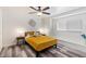 Cozy bedroom features wood look floors, a ceiling fan, and lots of natural light at 8209 E Heatherbrae Ave, Scottsdale, AZ 85251
